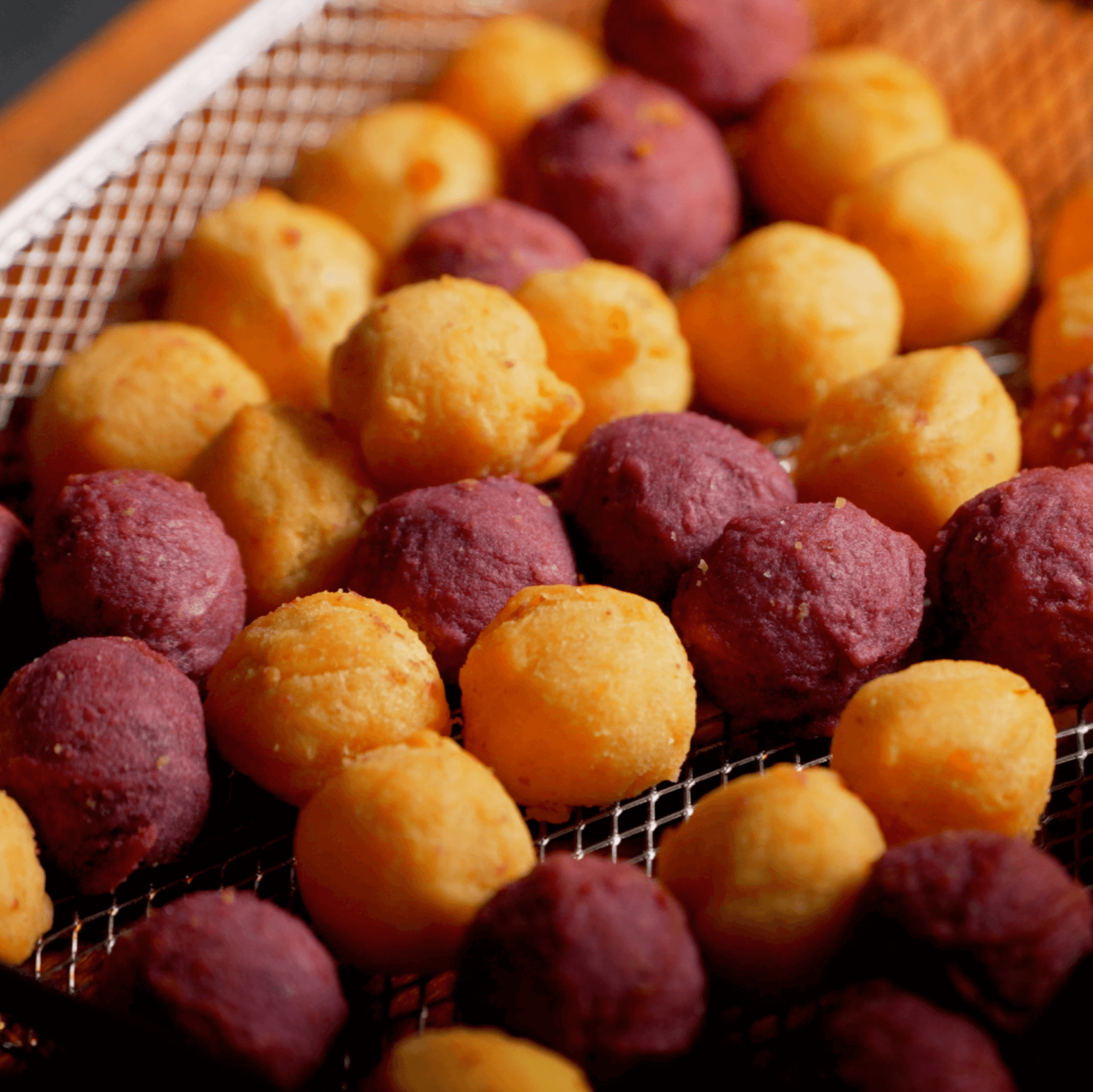Golden and purple Lumo sweet potato balls baked in oven basket until crispy