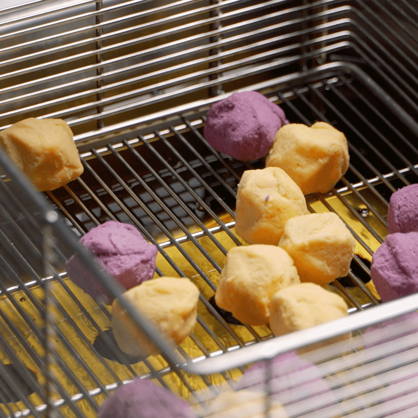 Lumo deep fryer raw frozen sweet potato balls in basket before frying