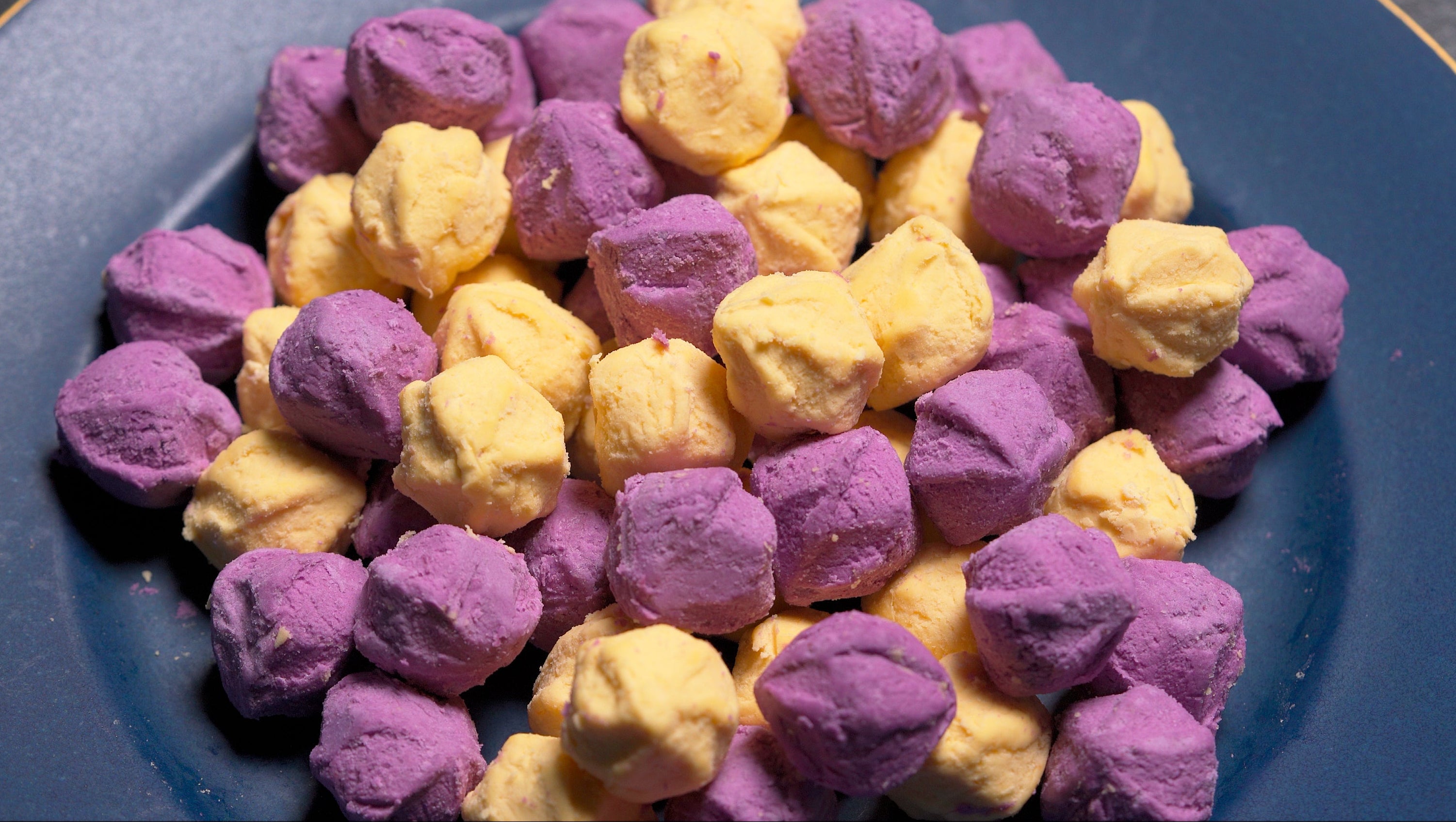 Frozen purple and yellow sweet potato balls in a top-down view.